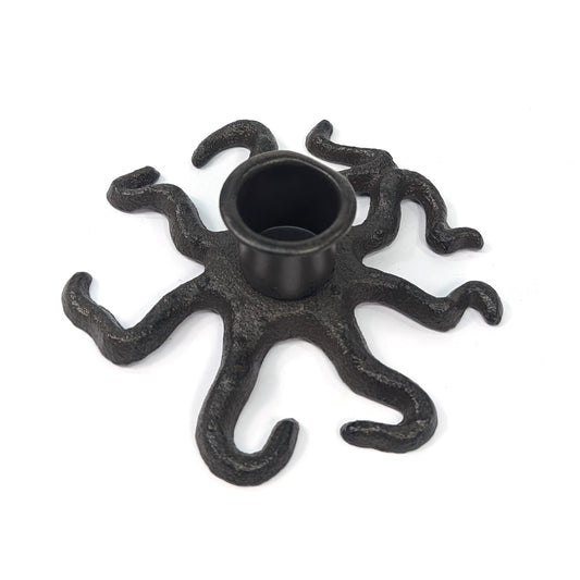 Cast iron octopus taper candle holder with curling tentacles on a white background