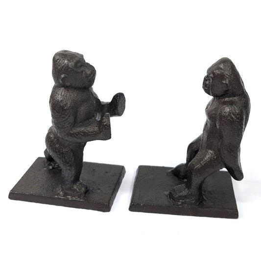 Pair of cast iron gorilla bookends, one pushing and one leaning backwards