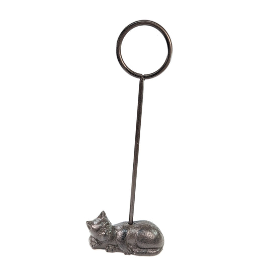 Full view of cast iron cat door stop with tall ring handle on a white background