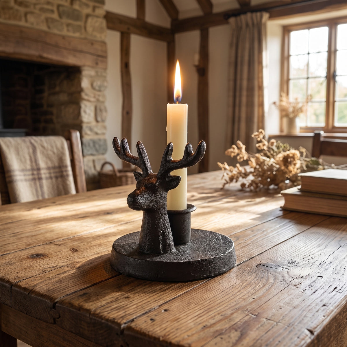 Stag candle holder with a lit taper candle on a farmhouse dining table