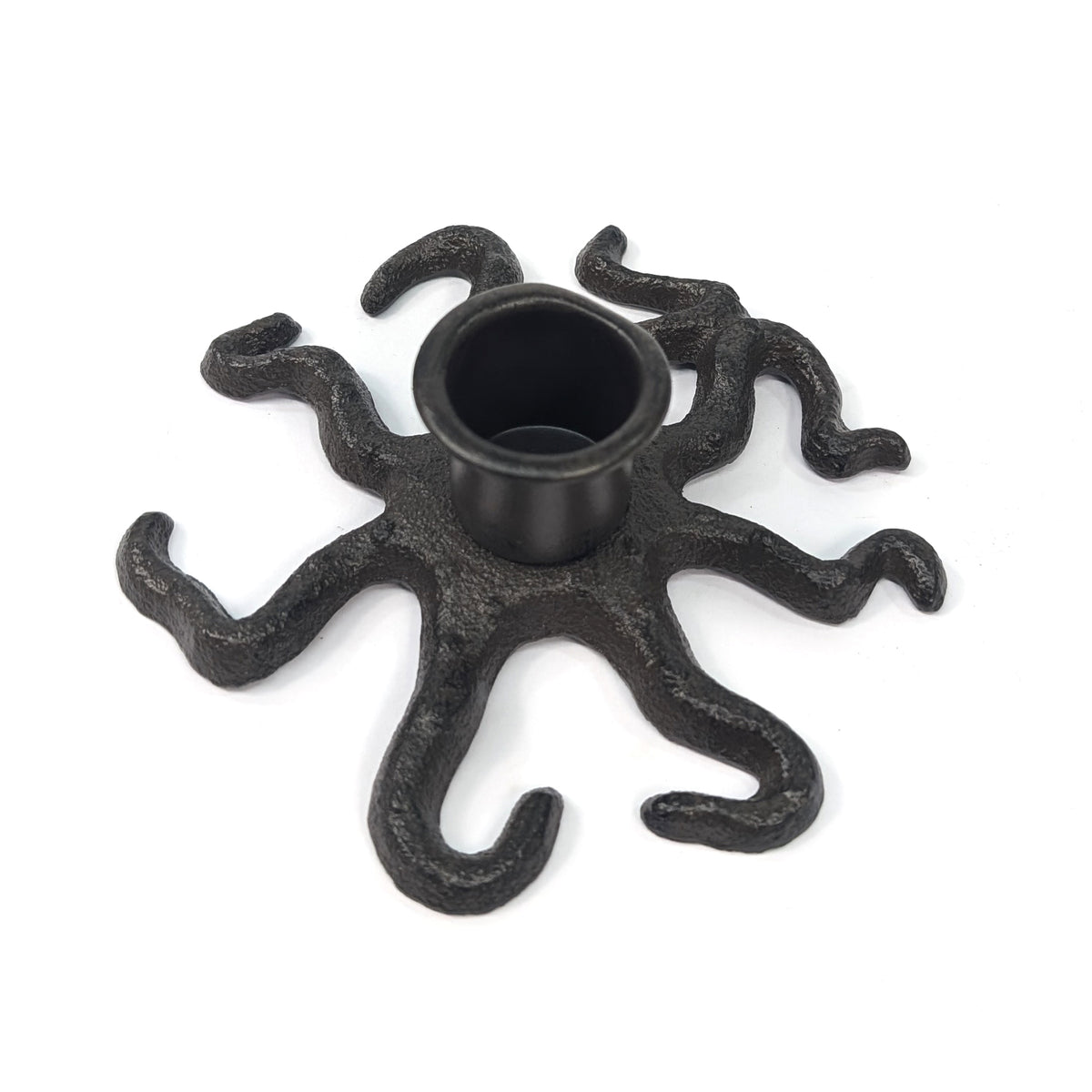 Cast iron octopus taper candle holder with curling tentacles on a white background