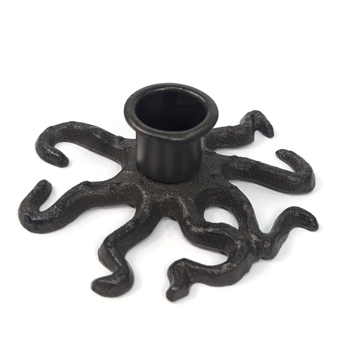 Low angled view of cast iron octopus candle holder showing its raised central socket