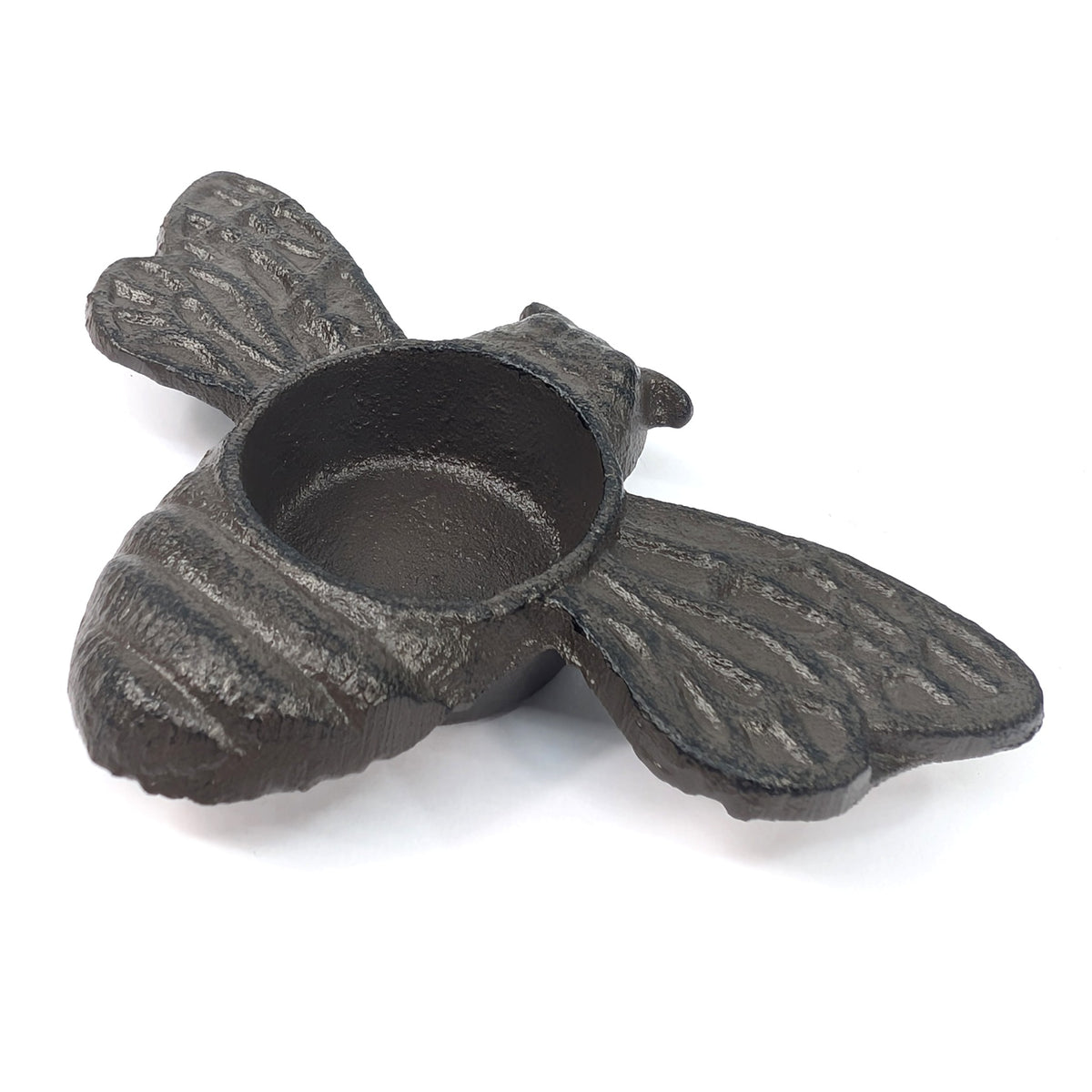 Rear view of cast iron bee tea light holder showing ribbed body and spread wings