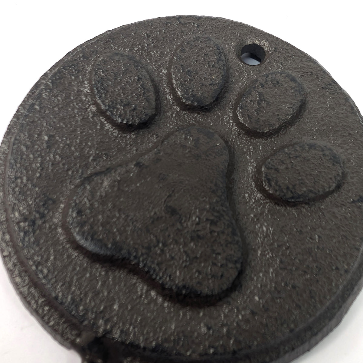 Close-up of the raised paw print and cast iron texture